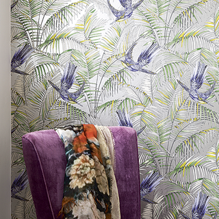 floral wallpaper wall and pruple armchair