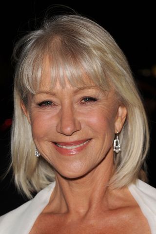 Helen Mirren smiling with icy blonde bob with fringe