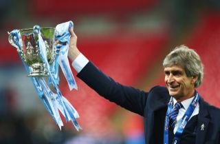 Manuel Pellegrini celebrates with the League Cup trophy after Manchester City's win over Liverpool in the 2016 final.