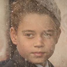 Prince George looks through a dirty carriage window and he stands on Buckingham Palace balcony wearing a suit alongside younger brother Prince Louis