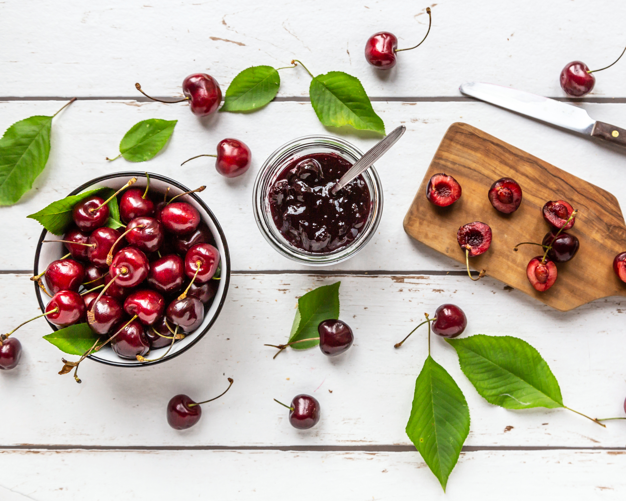 Cherries, cherry jam, and cutting board