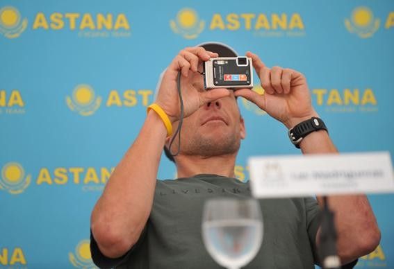 Lance Armstrong takes a photo of the assembled press.