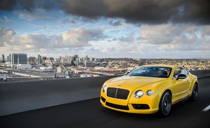 Yellow Bentley on terrace overlooking city