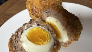 air fryer scotch eggs cooked and on a plate