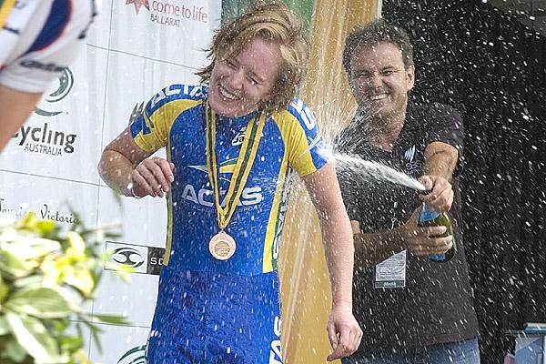 TV presenter from SBS and event commentator Michael Tomalaris sprays Alexandra Carle with some champagne after the presentations to the women's under 23 time trial.