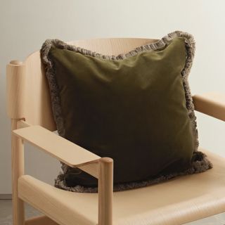dark green square cushion with fringed edge