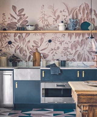 A kitchen with blue cabinets and red and white wallpaper