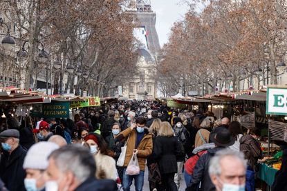 People walk through the streets of Paris.