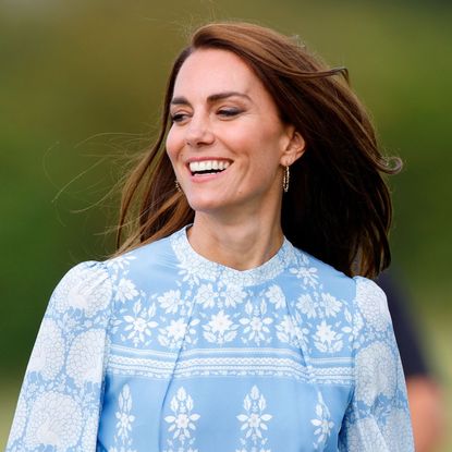 Catherine, Princess of Wales attends the Out-Sourcing Inc. Royal Charity Polo Cup 2023 at Guards Polo Club, wearing a white and blue dress