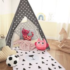 kids room with wooden flooring and star printed black tent