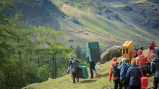 A group enjoys a bouldering clinic in the mountains