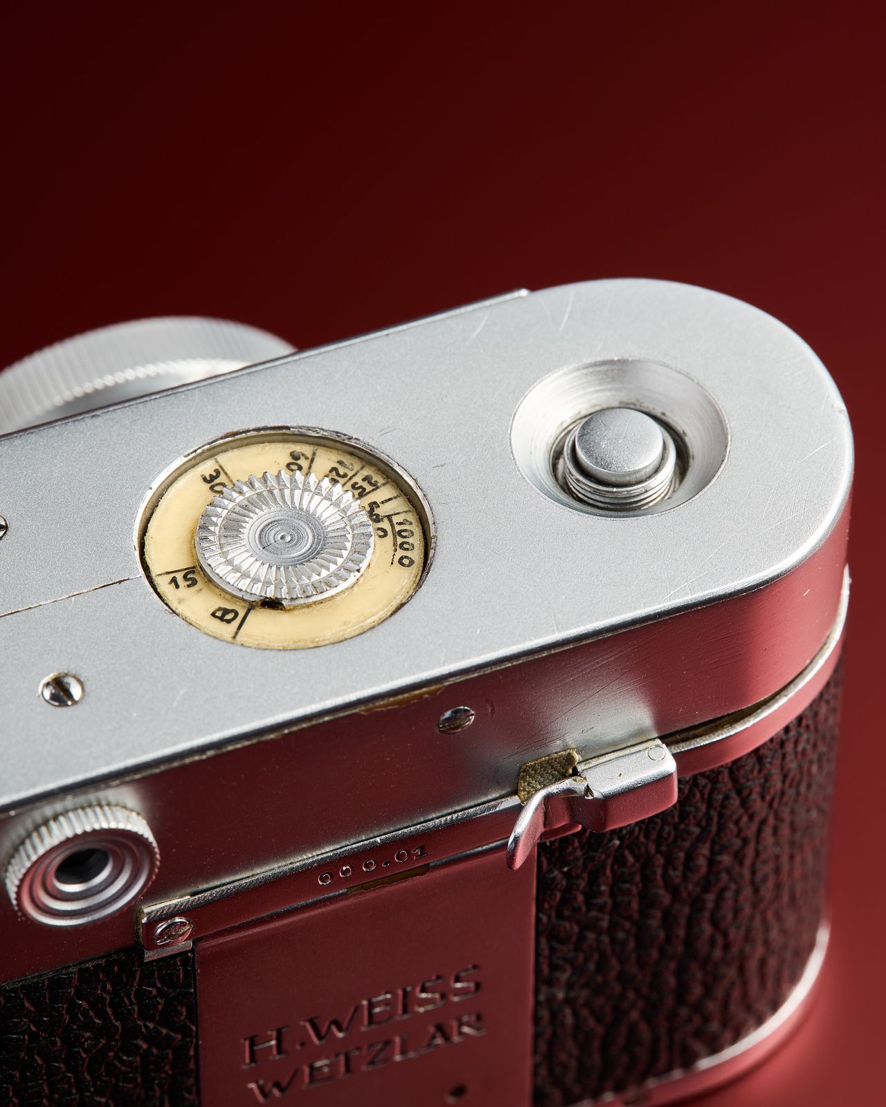 The working Leica Box camera prototype from the mid 1950s on a red background