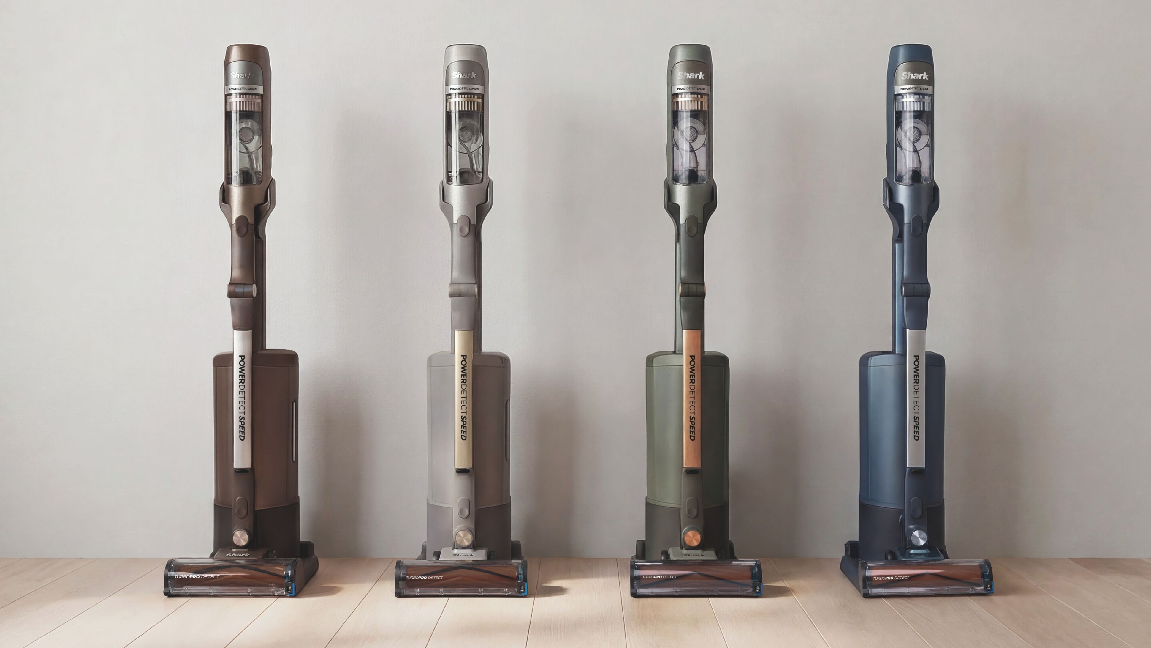 Shark PowerDetect Speed Clean &amp;amp; Empty vacuum cleaner in brown, beige, green, and blue lined up along a wall