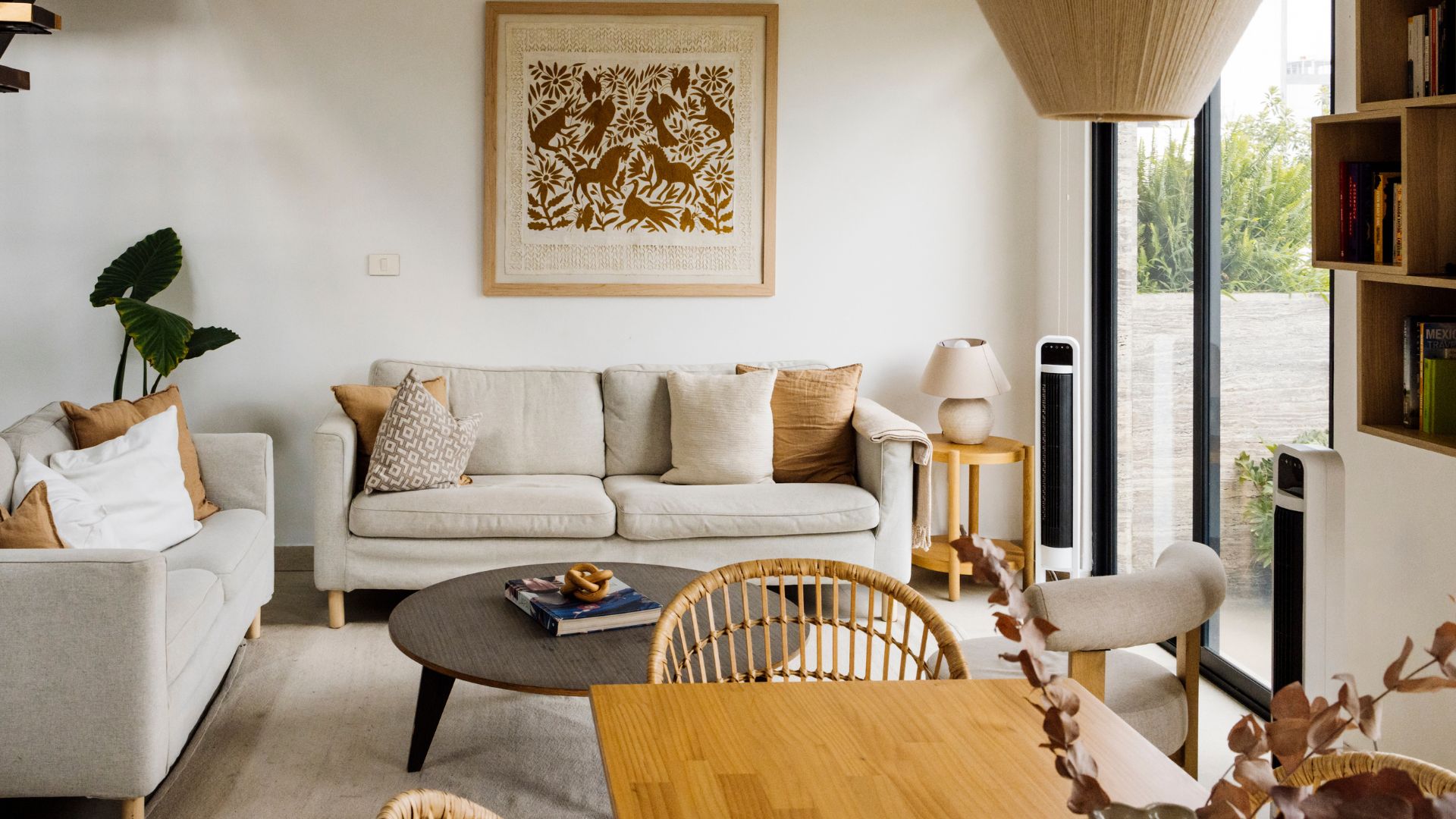picture of neutral living room with sofa on back wall