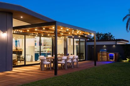 An outdoor area with a canopy of string lights