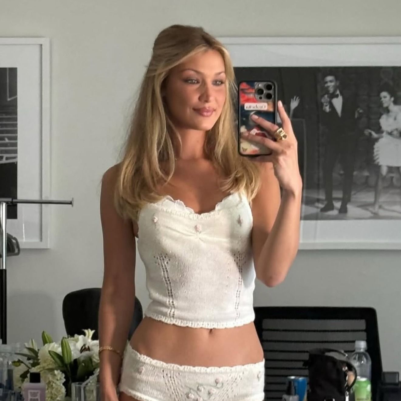Bella Hadid taking a selfie in a mirror with golden blonde hair
