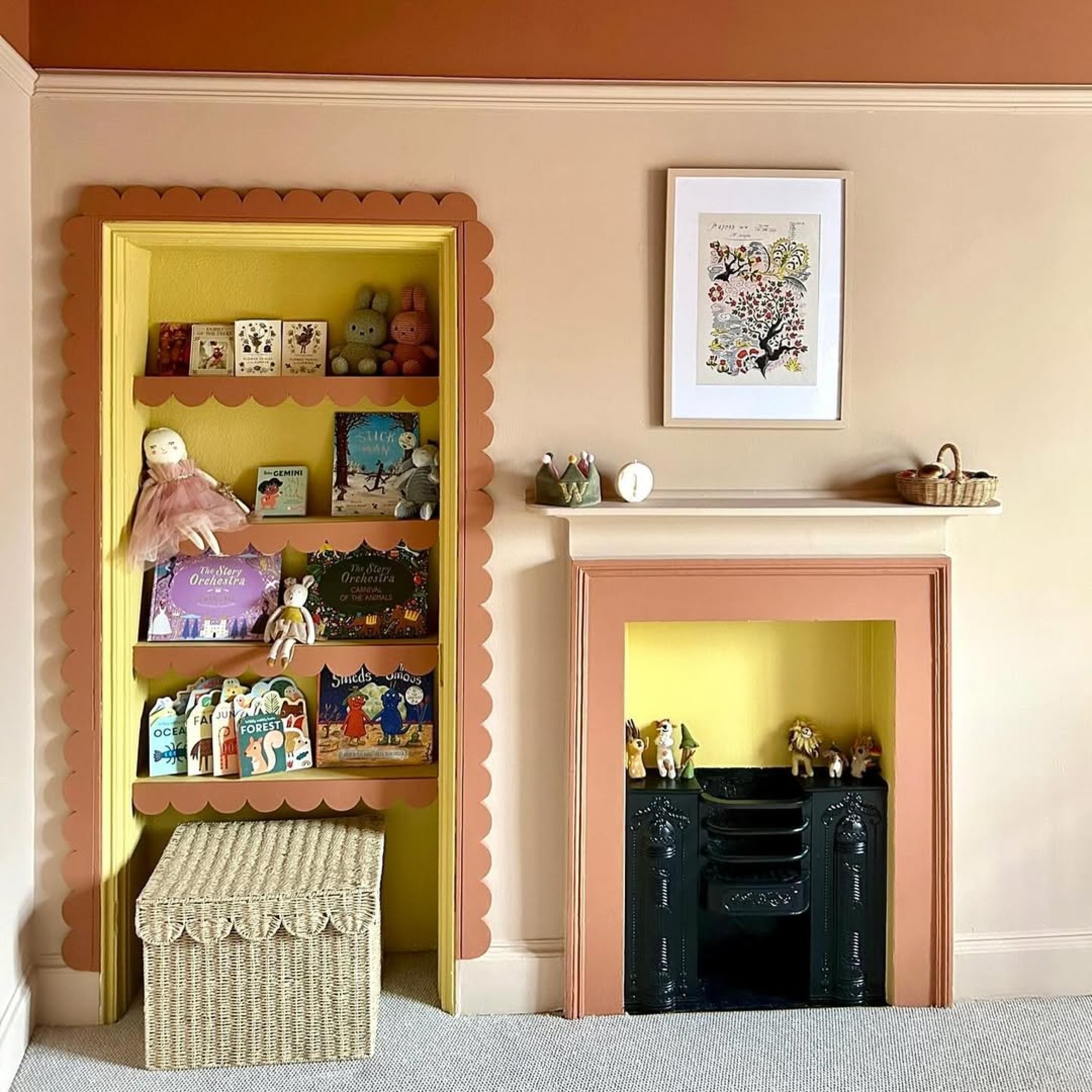 A pink-painted child's bedroom with an alcove bookshelf trimmed with a contrasting scalloped border