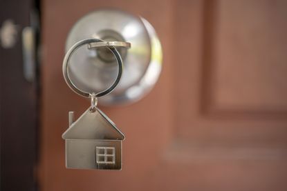 Silver house key in a door