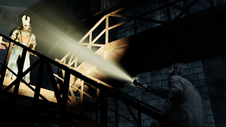 Alan Wake pointing a flashlight at a killer