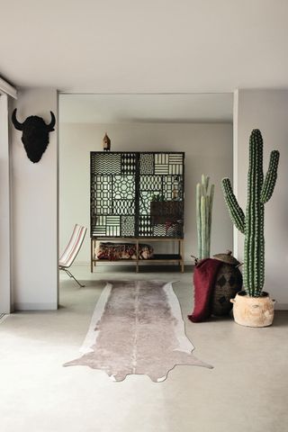 room with a large faux cactus