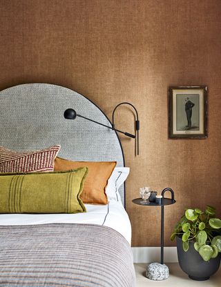 Neutral bedroom with textured wall and patterned headboard