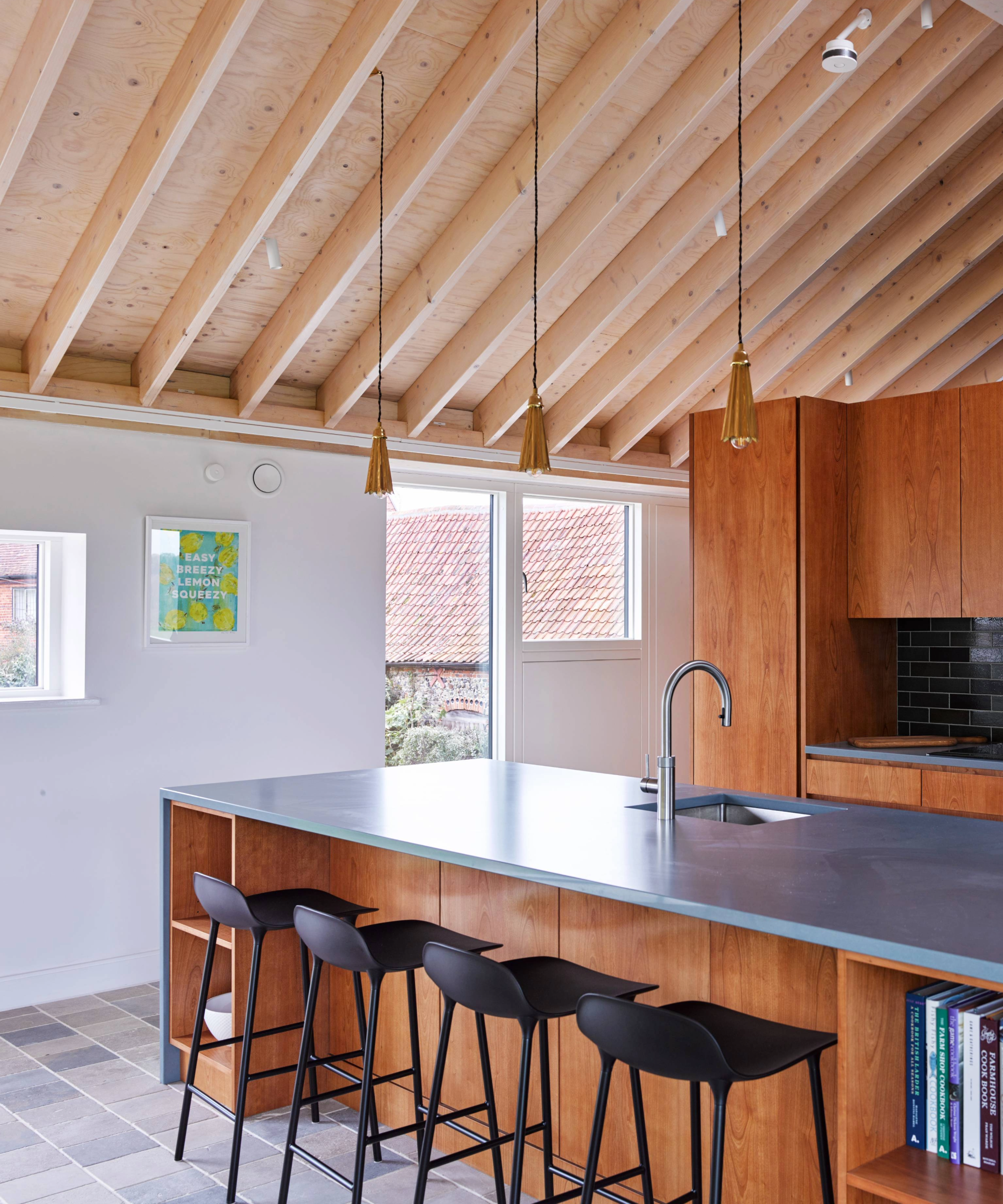 Kitchen with island, vaulted ceilings and wooden cabinets