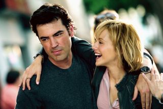 brittany murphy wrapping her arm around ron livingston and laughing in the movie little black book