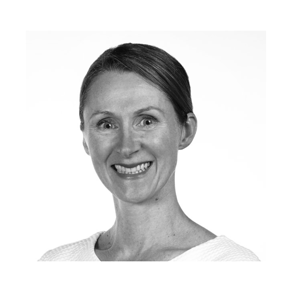 Black and white profile image of woman smiling at camera