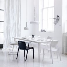 dining area with white wall and dining table and wooden floor