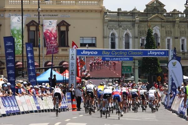 As seen on TV - the bunch passes under the start / finish barrier.
