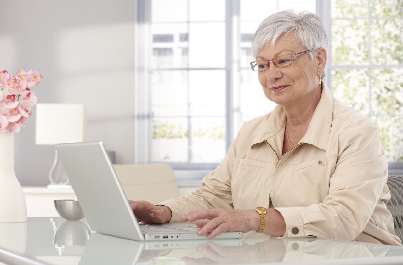 Grandmother using laptop at home