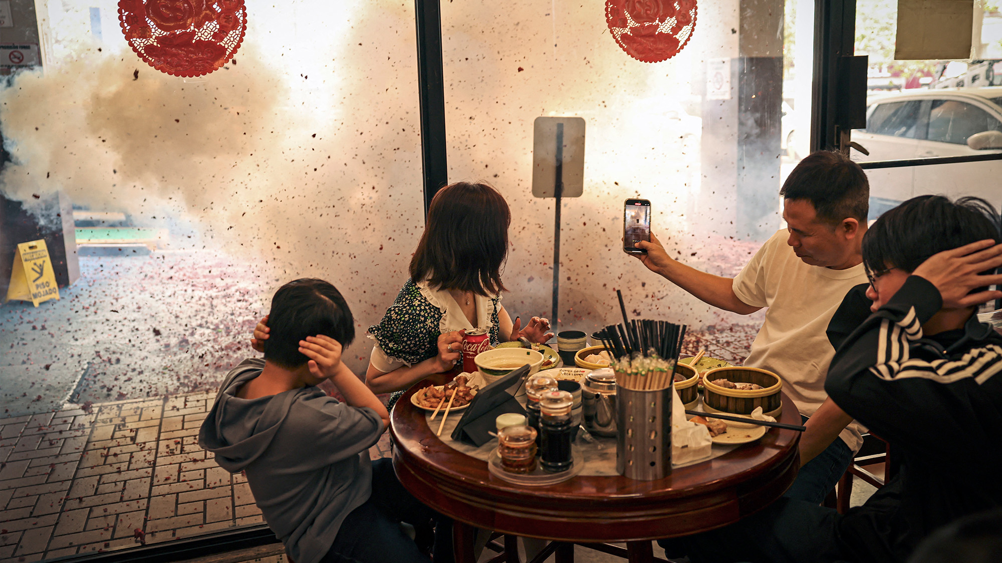 Guests react to firecrackers outside of a restaurant during Lunar New Year celebrations in Panama City, Panama