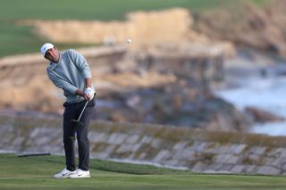 Scottie Scheffler hits a pitch shot on the 18th hole at Pebble Beach