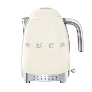 A cream white Smeg kettle with a stainless steel handle and faucet