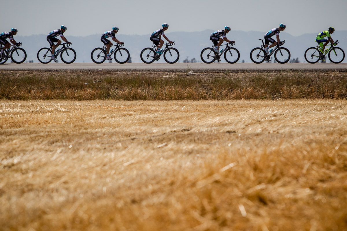 Riders go single file while chasing the break