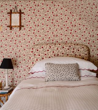 Pink wallpaper with red flowers in a bedroom