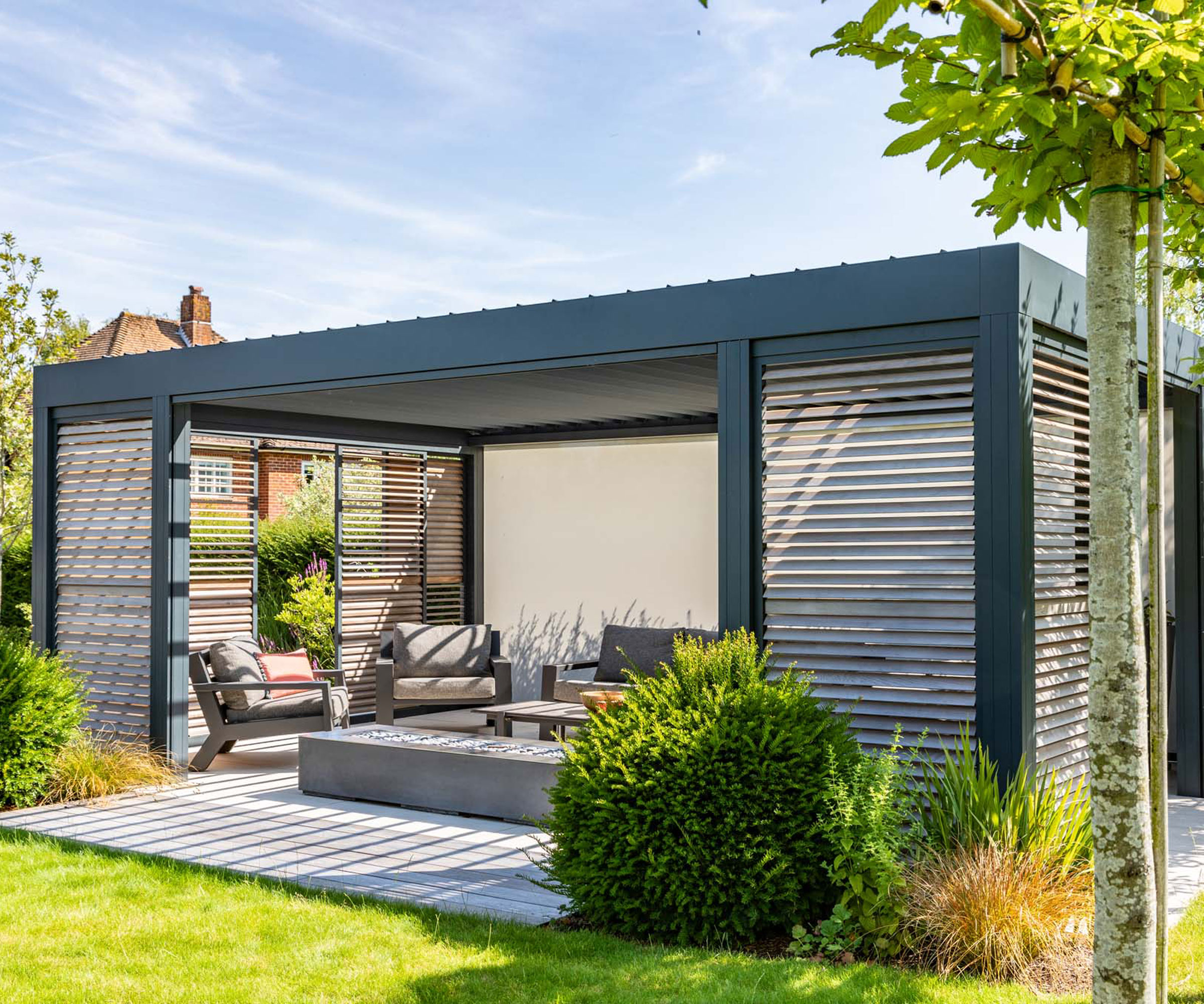 louvred pergola featuring a living room style outdoor space with firepit and garden furniture