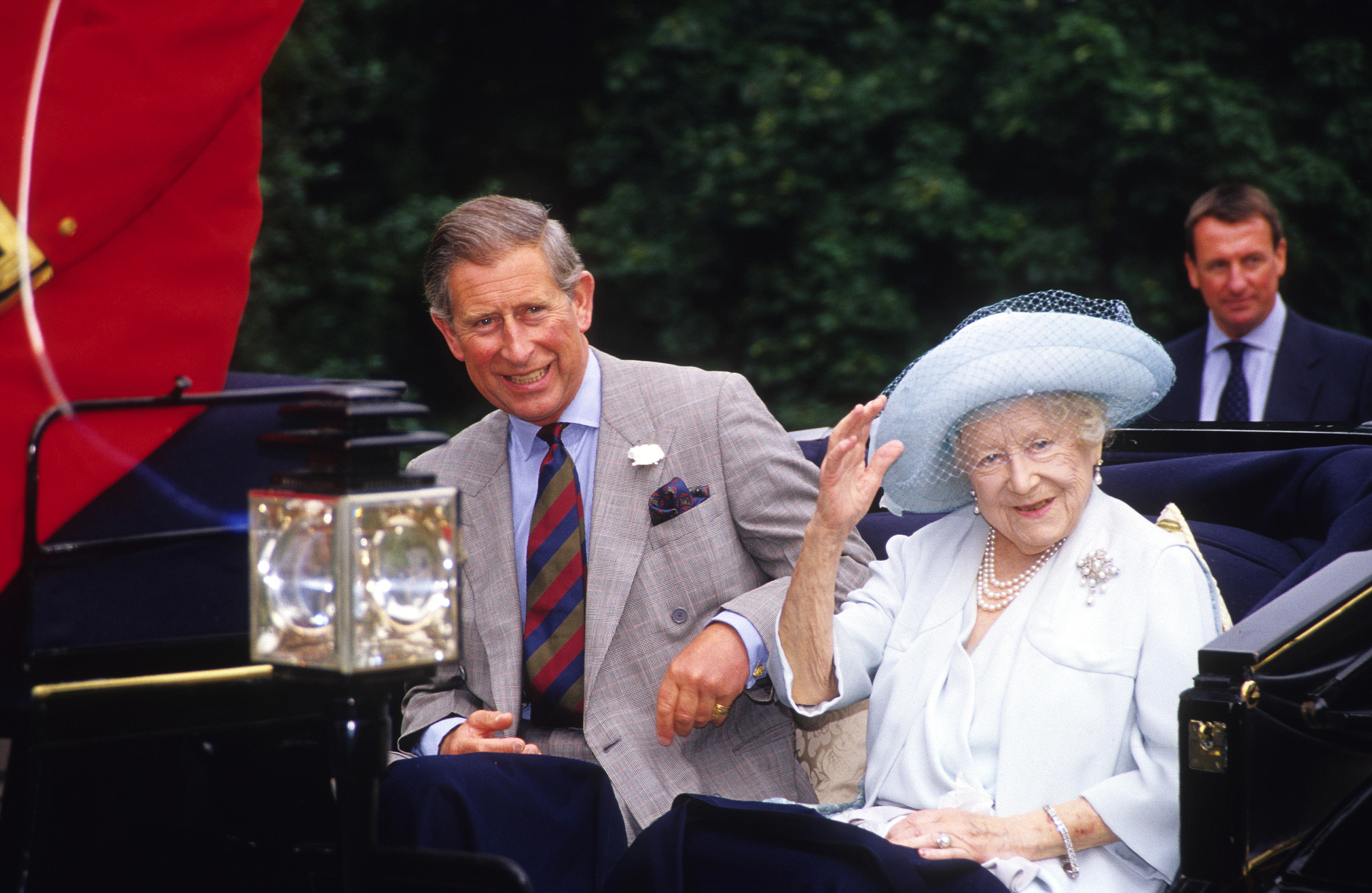 Prince Charles and the Queen Mother riding in a carriage