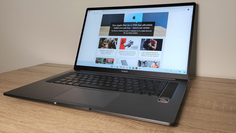 Honor MagicBook 16 (2022) review: man carrying laptop and coffee