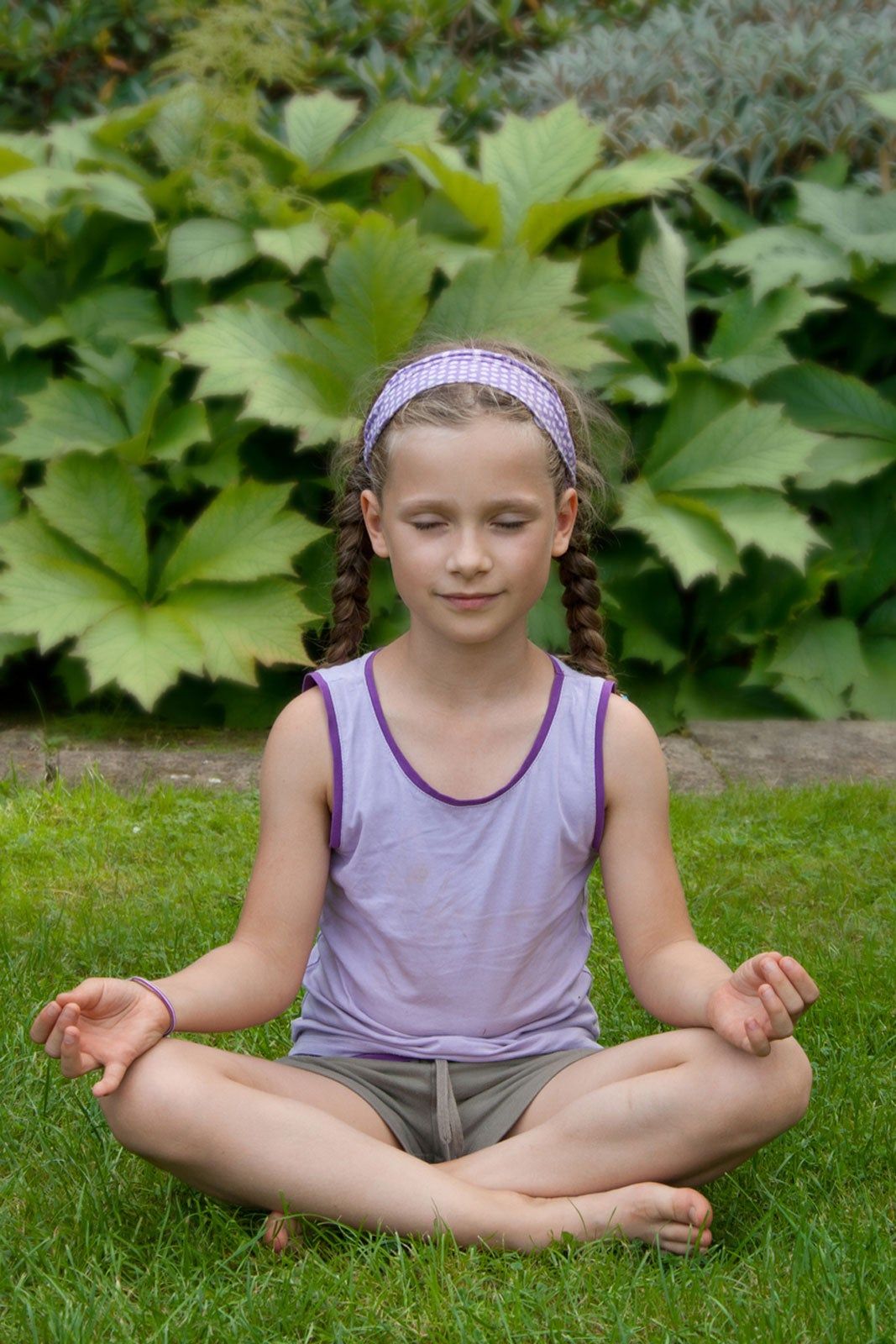 Child Doing Yoga In A Garden