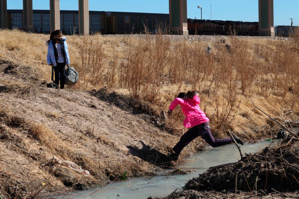 A migrant girl crosses into El Paso.