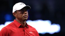 Tiger Woods wearing a red polo and white cap