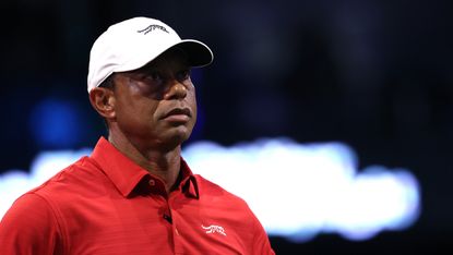 Tiger Woods wearing a red polo and white cap
