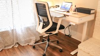 The Branch Ergonomic Chair next to a standing desk