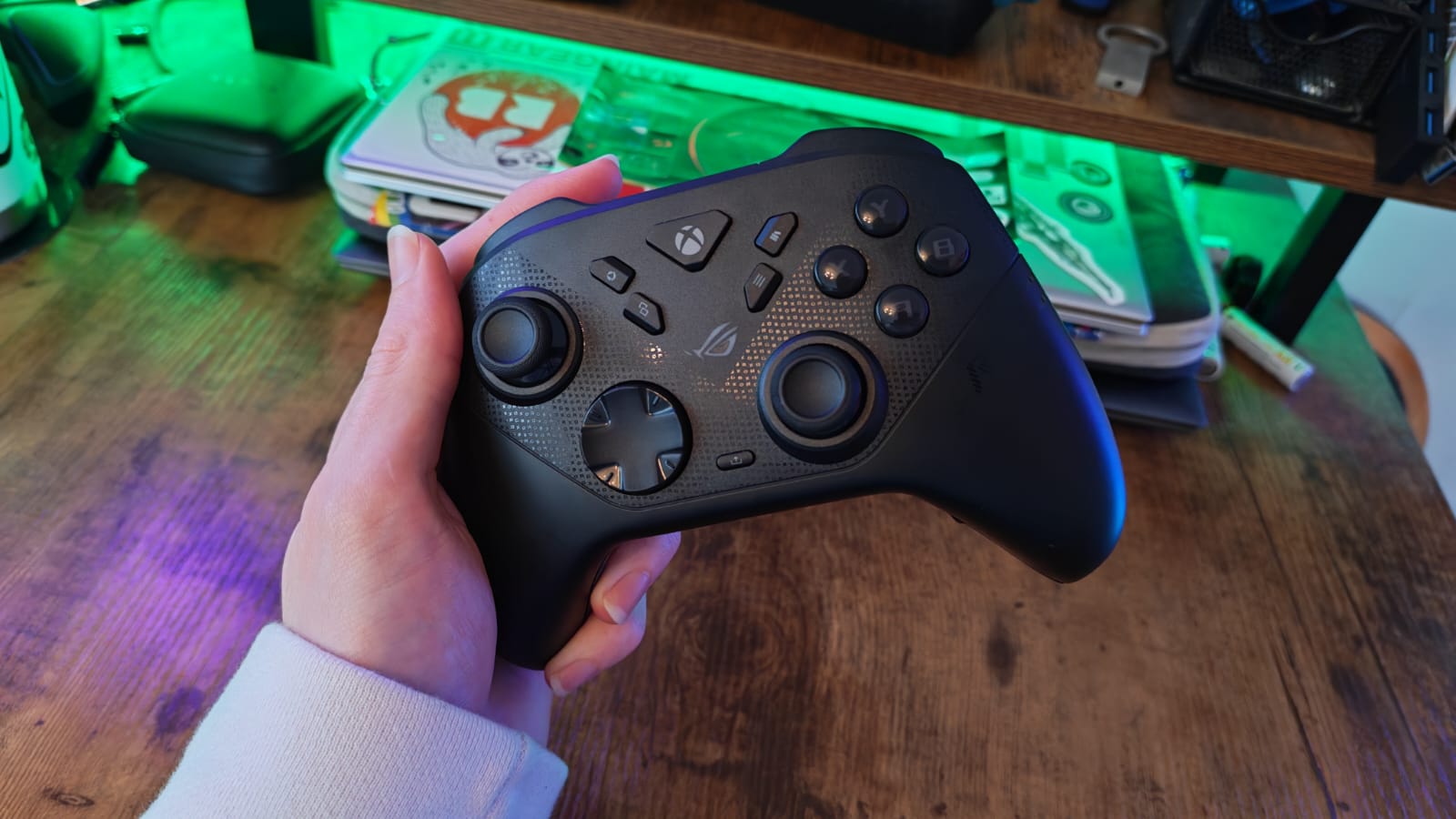 A reviewer holding the Asus ROG Raikiri 2