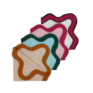 A set of 4 table napkins with colorful borders and a wavy finish