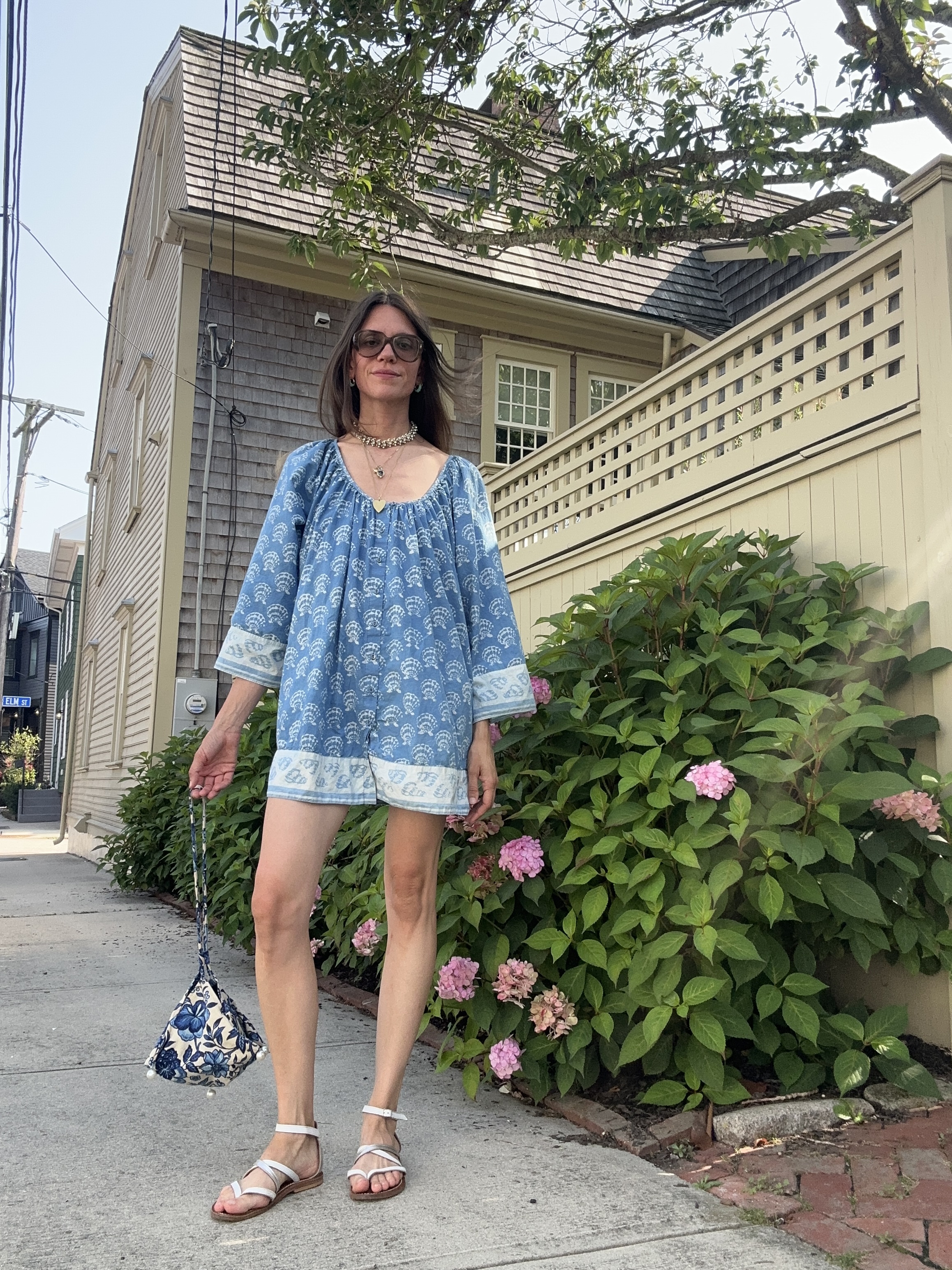 Julia Gall wears a short printed tunic dress with flat sandals