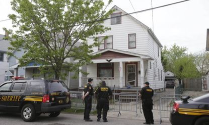 Sheriff deputies stand outside the Cleveland house where the three women were found. 