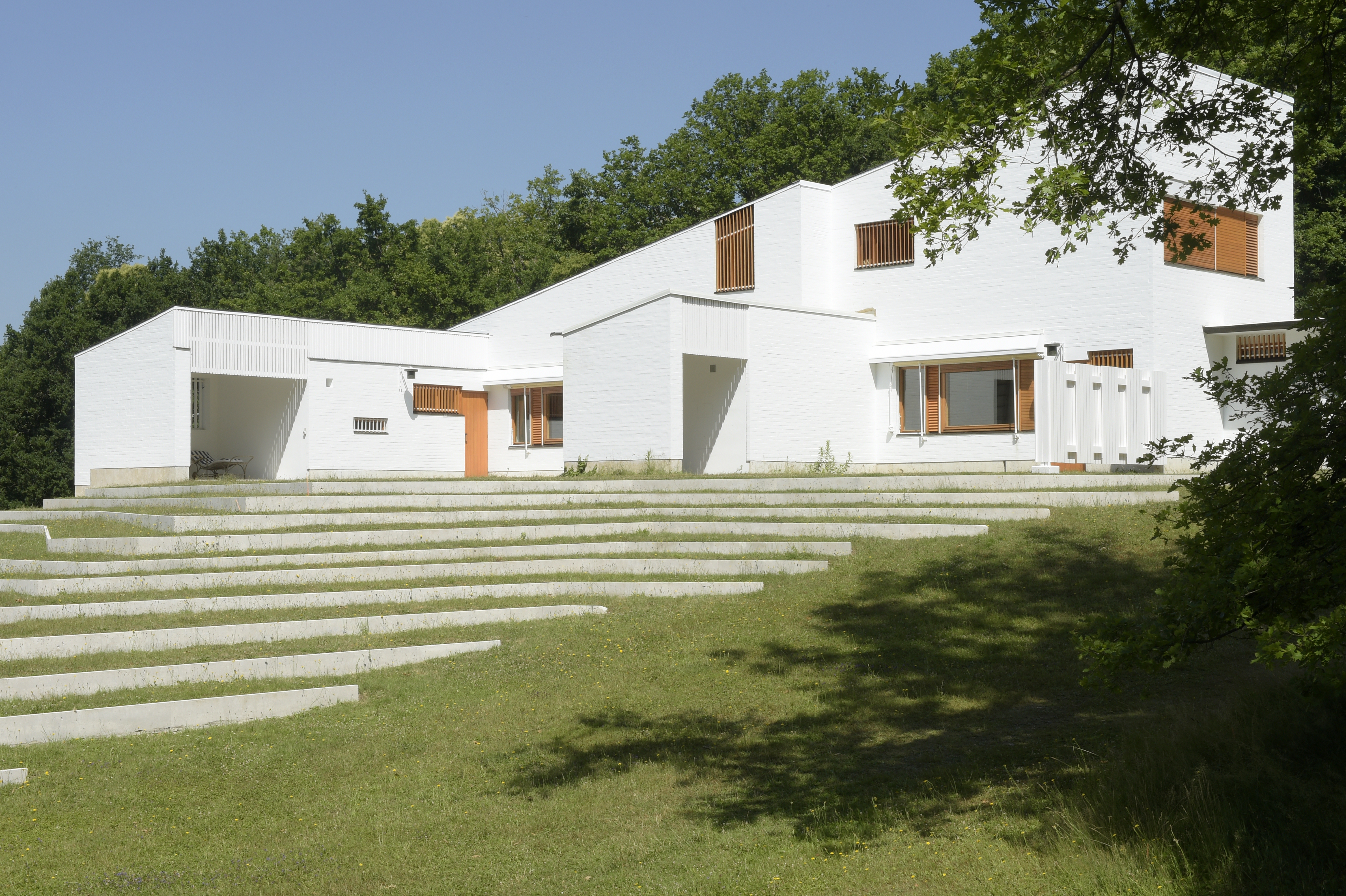the white, clear, crisp and restored Maison Louis Carre by Alvar Aalto against blue skies