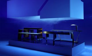 Electric blue background with console tables on a platform